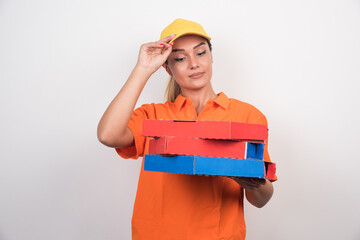 Pizza delivery woman holding pizza boxes on white background