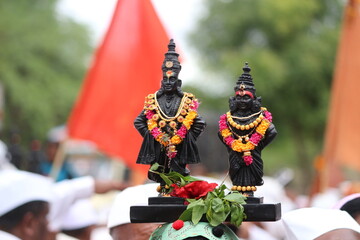 Warkari Carrying Vitthal Rukmin Statue on head in Wari to Pandharpur