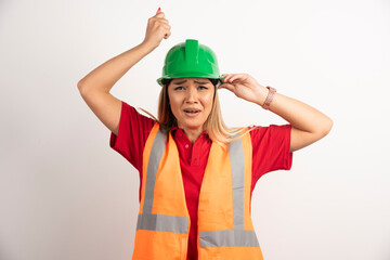 Female worker posing with helmet and uniform