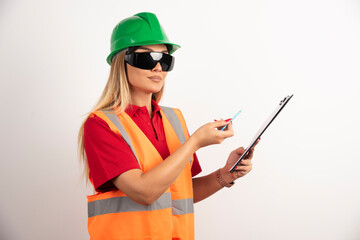 Woman employee showing with pencil on clipboard