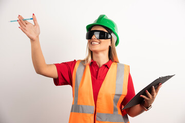 Smiling woman employee raising hand with pencil
