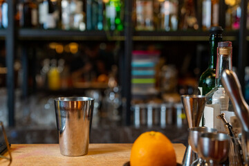 Background of bartender preparing mixed beverage cocktail drink from shaker into cocktail glass on...