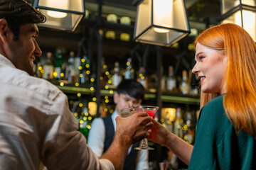 Caucasian man and woman flirting each other while hangout nightlife party at restaurant bar. Attractive female have romantic dating with boyfriend celebrating holiday event together at nightclub