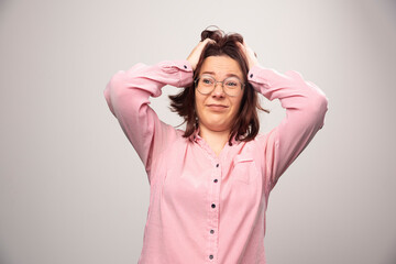 Portrait of pretty woman in pink clothes posing on a white background