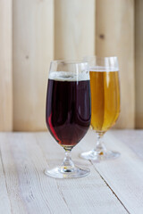 Two glasses of beer on wood background with copyspace