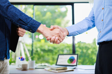 Business people shaking hands, finishing up meeting at home office