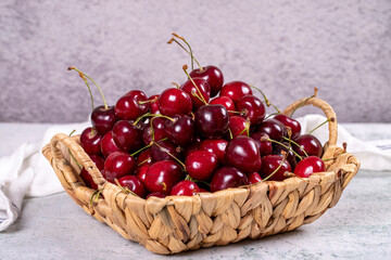 Fresh cherry. Ripe cherries in a basket on a stone background. Bulk cherries. close up