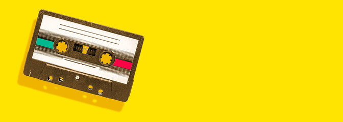 Fototapeta premium vintage audio cassette on yellow background with copy space