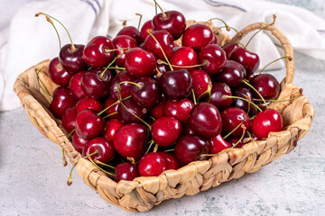 Fresh cherry. Ripe cherries in a basket on a stone background. Bulk cherries. close up