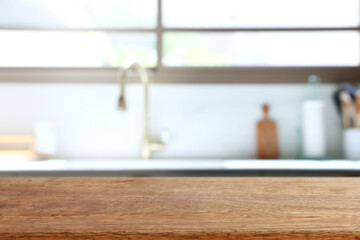 empty table board and defocused modern kitchen background. product display concept