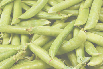 Fresh pea pods as background. Top view.