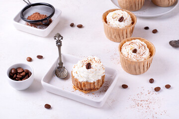 Mini cheesecake with cappuccino taste topped with whipped cream and coffee bean. Portion size dessert