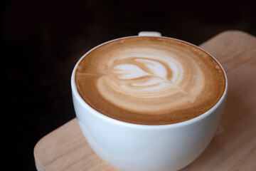 Latte Art Hot coffee in Black color background.