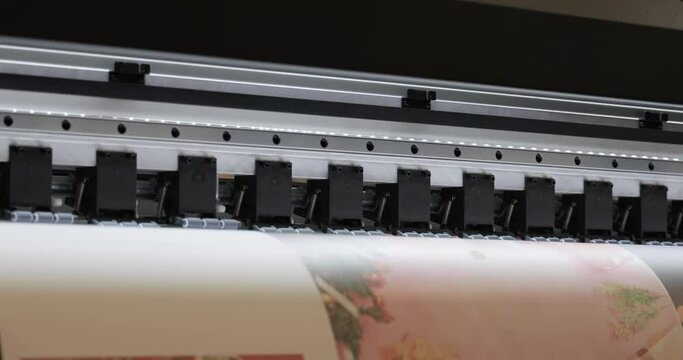 Modern Digital Large format UV printer. Printing production technologies. UV pinning is the process of applying a dose of low intensity ultraviolet light to a UV curable ink