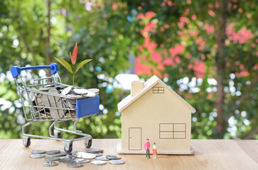 A lot of money was in a small cart with a tree on top. with houses and miniature figures placed on...