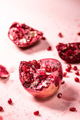 Fresh pomegranate on pink background