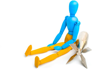 Wooden doll of Ukrainian flag colors, on gray background