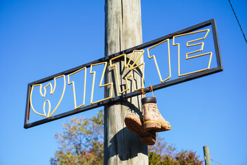 Shoes Hanging From Wire and Sign