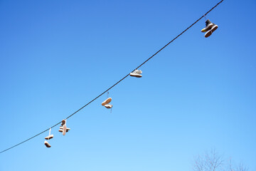 Shoes Hanging From Wire and Sign