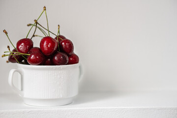 Ripe juicy cherries on gray background