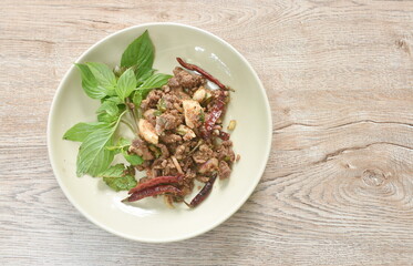 Thai spicy slice beef salad eat couple fresh basil on plate