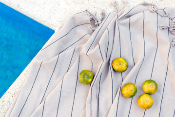Tangerines lie on the picnic blanket. Summer concept.