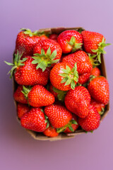 Fresh strawberries in box, summer berry top view - healthy food and vitamin concept