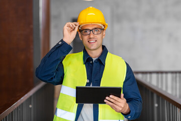 architecture, construction business and building concept - happy smiling male architect in helmet...