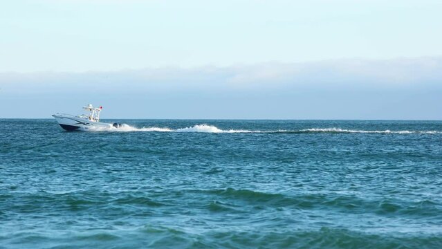 wide View from beach of Speeding Boat, Cascais, Europe