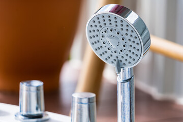 Chrome plated shower head, shower treatments. The girl takes a shower. Shower accessories.