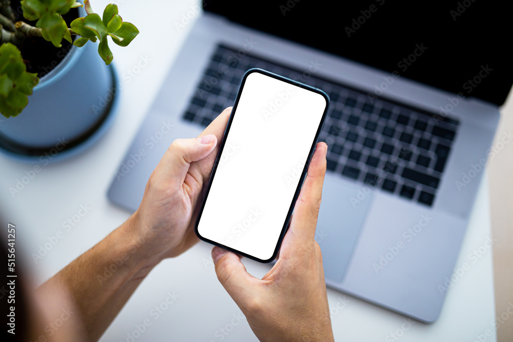 Poster man using smartphone blank screen frameless modern - top view, laptop keyboard in background