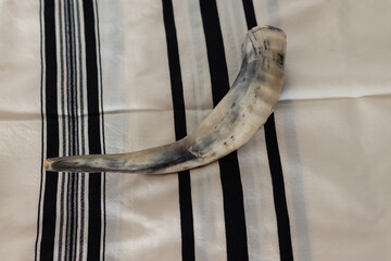 shofar made from the horns of a lamb - on a background of talit