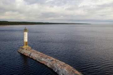 Vuokhensalo lighthouse and Ladoga lake on cloudy day. Motornoye, Leningrad Oblast, Russia.