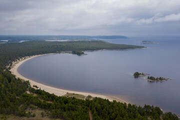 Aerial view of Kojonsaari island beach and  Ladoga lake on cloudy summer day. Ladoga Skerries National park, Karelia, Russia.