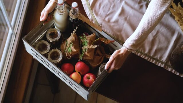 woman puts a healthy breakfast box on the table