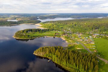 Aerial view of Yakimvarsky gulf of Ladoga lake and Sorola village on sunny summer evening. Karelia, Russia.