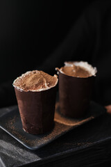 Italian dessert tiramisu in glass made from chocolate. Traditional dessert from Italy. Tasty food. Dessert with mascarpone cheese.