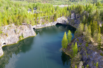 Drone view of flooded marble quarry on sunny summer day. Ruskeala mountain park, Karelia, Russia.
