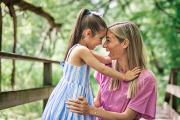 Fototapeta premium mother with his daughter having fun outside in forest
