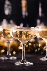Champagne glasses on a dark background.