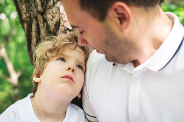 Fototapeta premium boy with father in summer park. Child in green woods