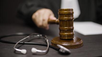 Judge striking gavel in health court, punishment for medical malpractice