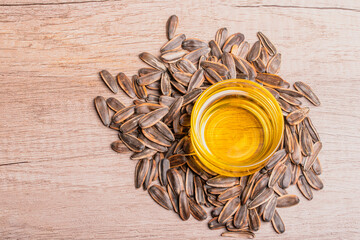 Sunflower oil in a glass cup and dried sunflower seeds