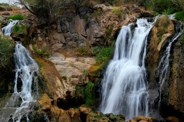 Fototapeta na wymiar A part of Muradiye Selalesi Waterfall, which flows down from the rocky mountains, near the city of Van, in the region of Eastern Anatolia, Turkey