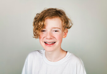 redheaded teen with white shirt on studio