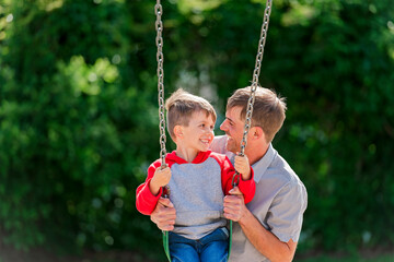 cute five year old boy outside portrait with father on the playground