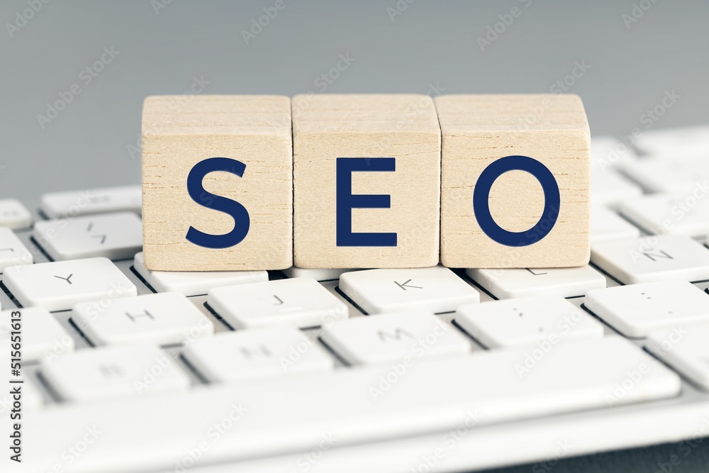 Poster seo word on wooden blocks on computer keyboard.