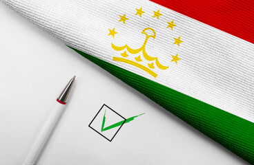 Pencil, Flag of Tajikistan and check mark on paper sheet