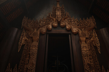 Low angle view of a the Elaborate yet Spooky Entryway to The Black House (Baan Dam) in Chiang Rai,...