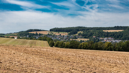 Fototapeta na wymiar View over the German countryside in Rhineland-Palatinate with plowed agriculture fields